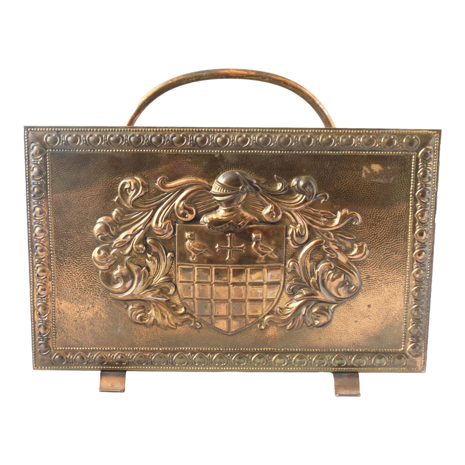 1930s French Coat of Arms Magazine Rack: This midcentury French brass magazine rack features a striking family coat of arms pressed into the brass, along with brass handles and its original lining. The intricate scrollwork and sturdy