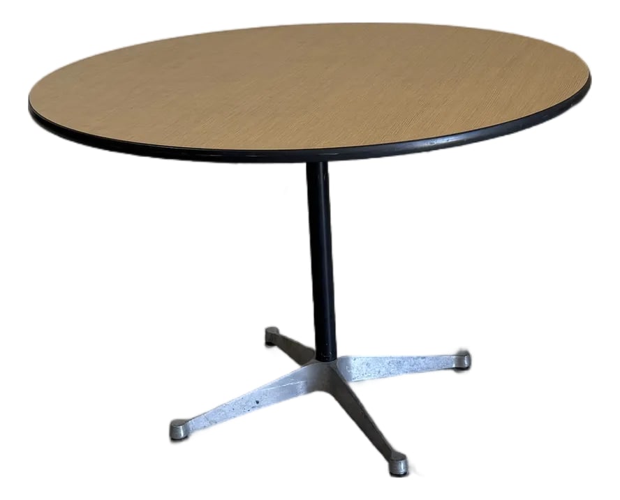 Mid Century Modern Eames Herman Miller Round Pedestal Table: Mid century modern round pedestal table by Eames for Herman Miller. Universal metal base and wood grain laminate top. In excellent vintage condition. Dimensions: 42"W x 42"D x 28.75"H Condition: Alter