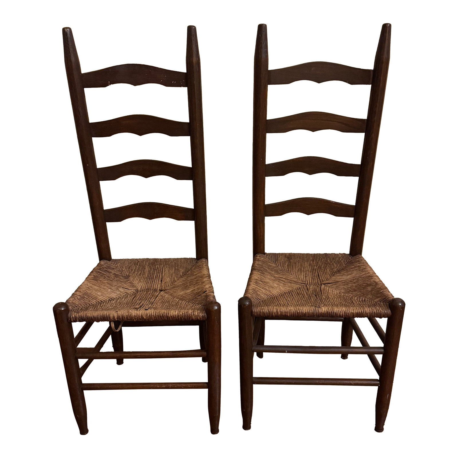 Pair of Antique Ladder-Back Rush Seat Chairs: Handsome pair of antique ladder-back chairs featuring turned wood frames and hand-woven rush seats in a traditional four-quadrant pattern. The tall ladder backs have softly scalloped slats and elegant