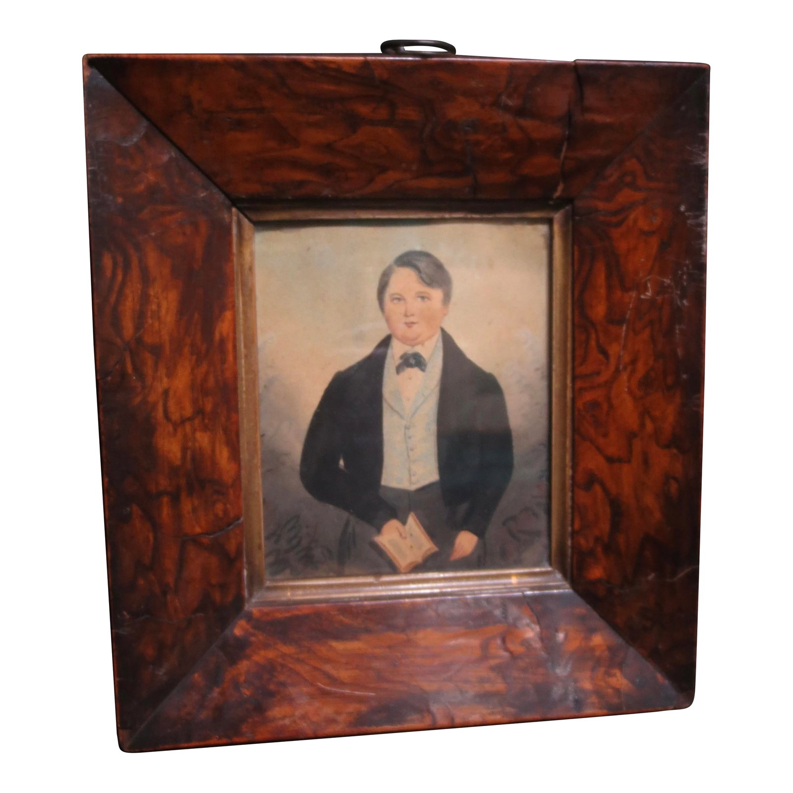 19th Century Portrait of a Young Man Watercolor: Classic portrait of a fine young man from the 19th century. Portly and well-dressed, holding a small book, likely a bible copy. Formal dress with a black collar and waistcoat. Well drawn in a folk nai