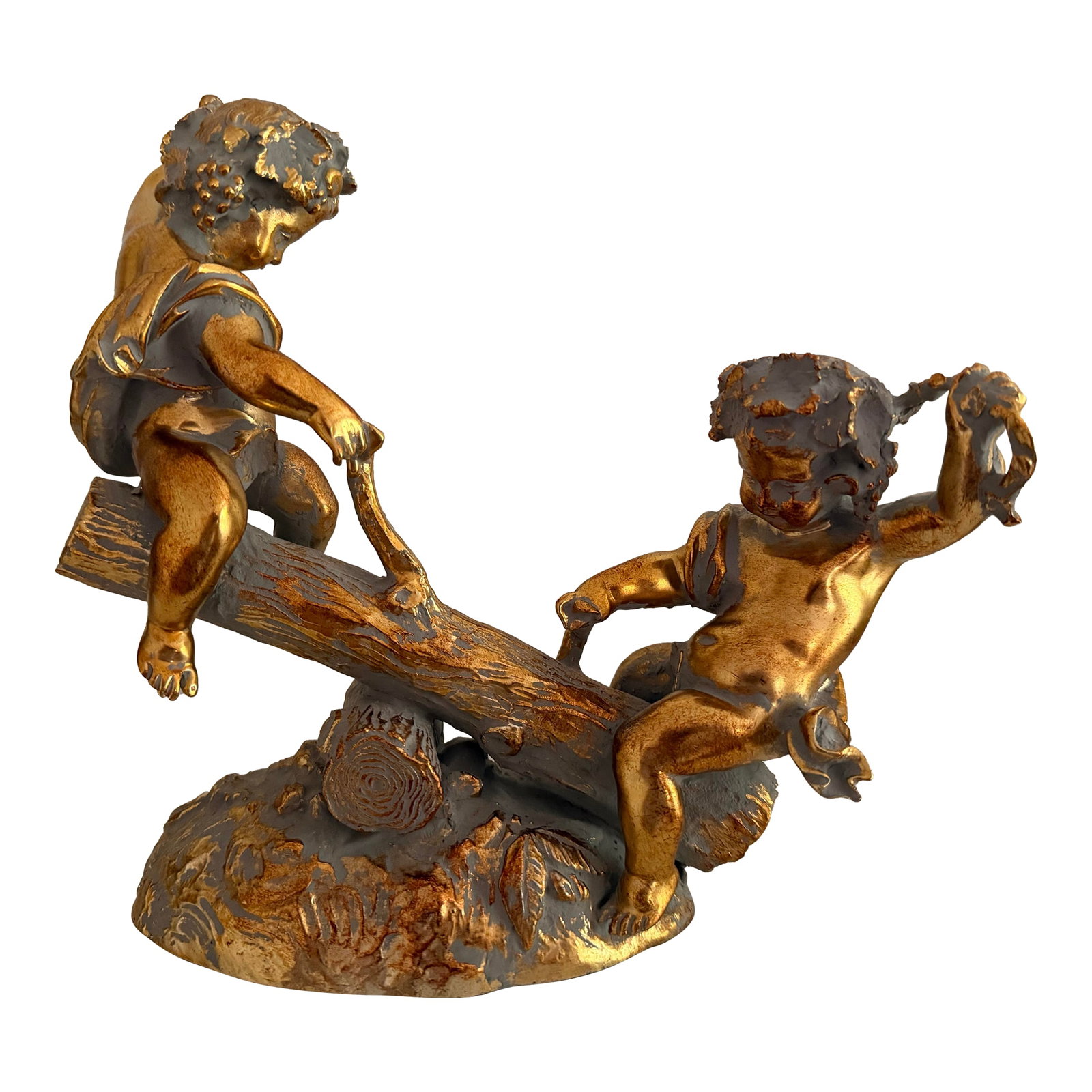 Vintage Sculpture of Gold Colored Cherubs on Log Seesaw: Charming sculpture of two playful angelic cherubs on a log seesaw. The vintage sculpture is purposefully presented with a "tarnished" gold surface reminiscent of a French antique from the ancien