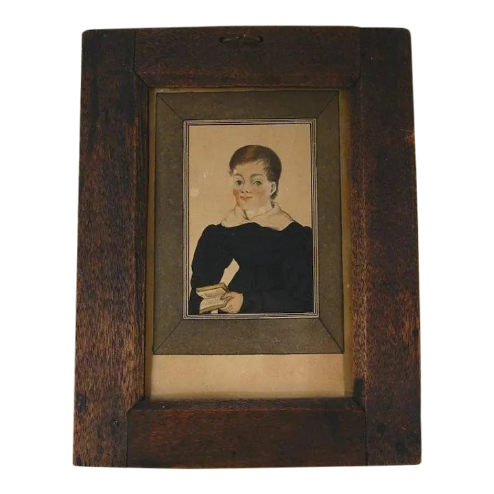 Antique Early 19th Century American Federal Miniature Portrait Painting of a Boy Holding a Book in I: Antique early 19th c. watercolor and ink portrait of a boy with rosy cheeks holding a book. Old gum label on back identifies sitter. Frame is period with hand made nails. Connecticut origin. Measures