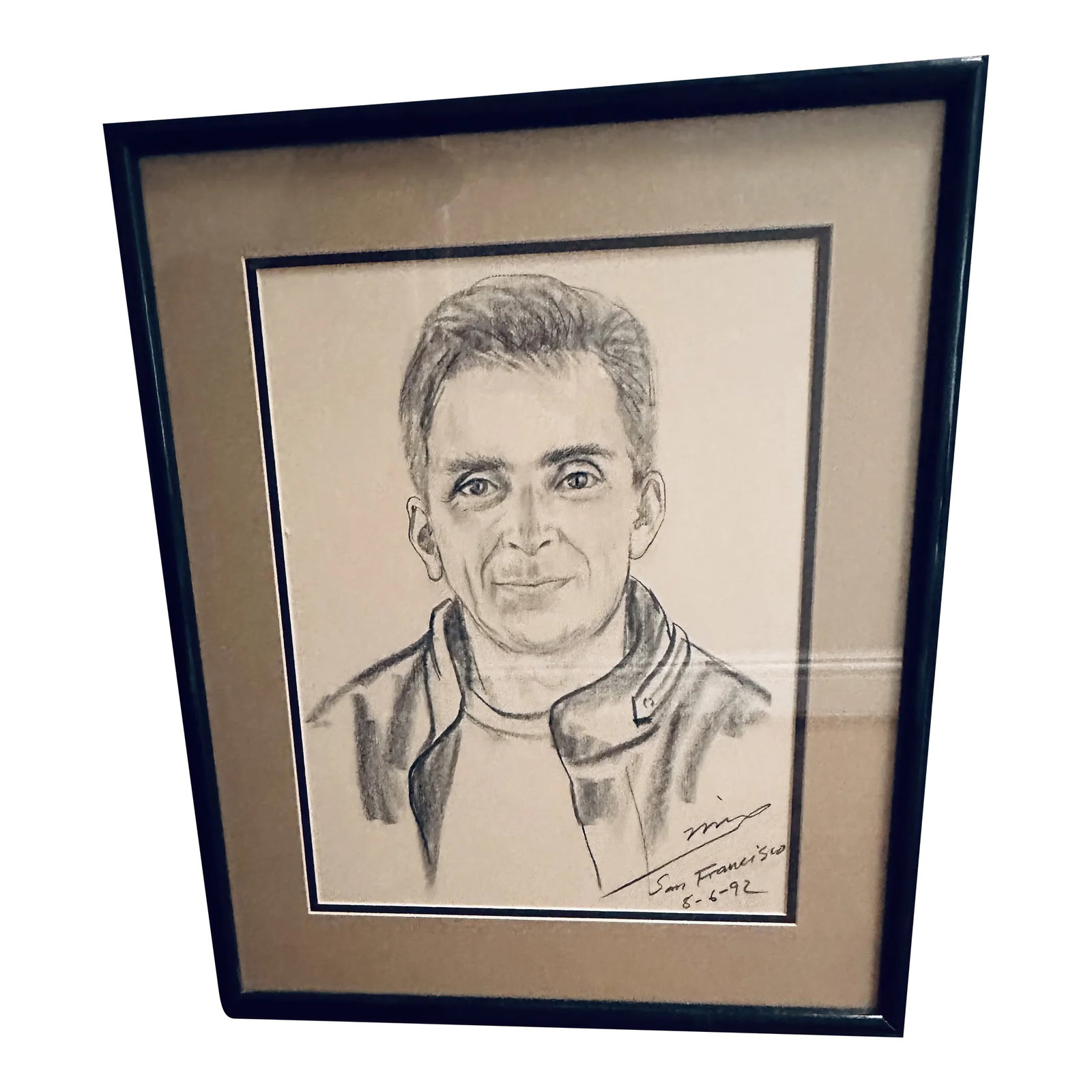 Vintage 1992 Framed Charcoal Portrait of a Man: Fantastic signed 1992 charcoal portrait of handsome, cheeky man. Great fine detail. Professionally framed in Honolulu, Hawaii. Under glass with double mat. Frame of heavy black acrylic. Measuring