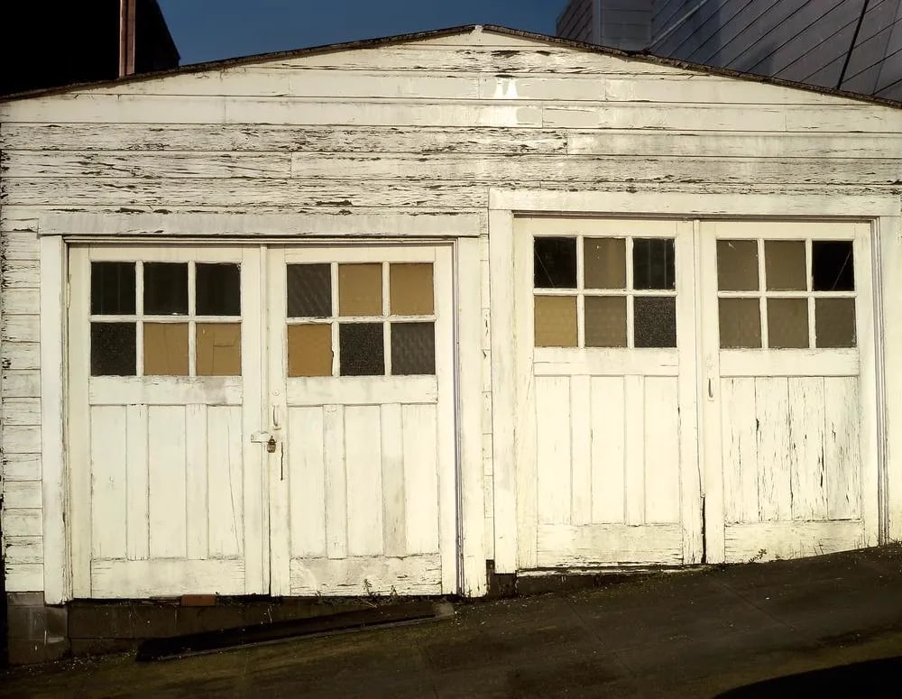 Contemporary Night Photograph "Double Garage" by John Vias: Note from the artist, John Vias: "If you look closely, you can see the repeating circular and cross-hatch patterns in the windows of this old garage. I took this picture in San Francisco." This 11" x 