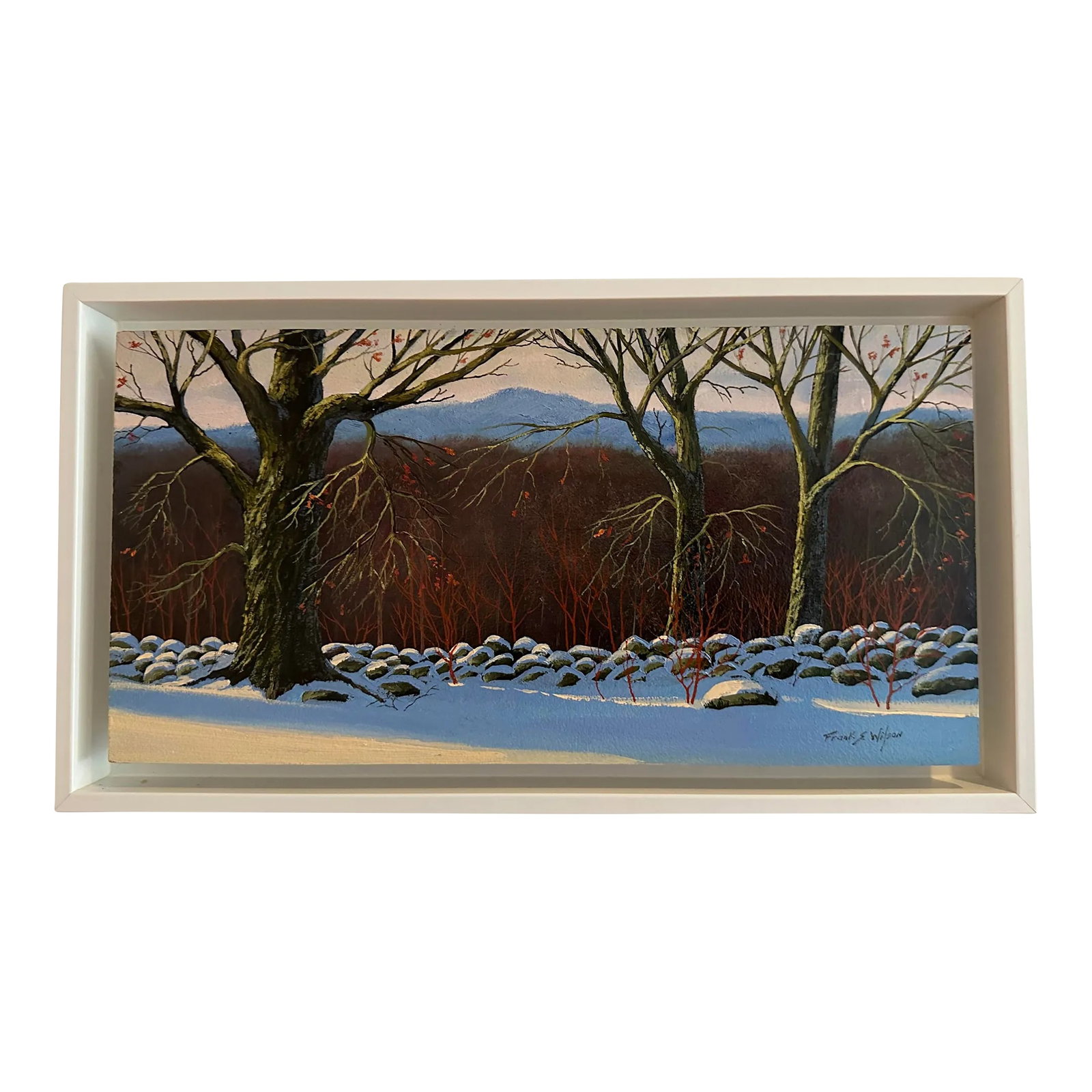 "Vermont Wall With Snow" Realist Landscape Framed Oil Painting: "Vermont Wall With Snow" by Frank S. Wilson is a framed oil painting on board that captures the beautiful landscape of Vermont in the middle of winter. The painting displays smooth brushstrokes and