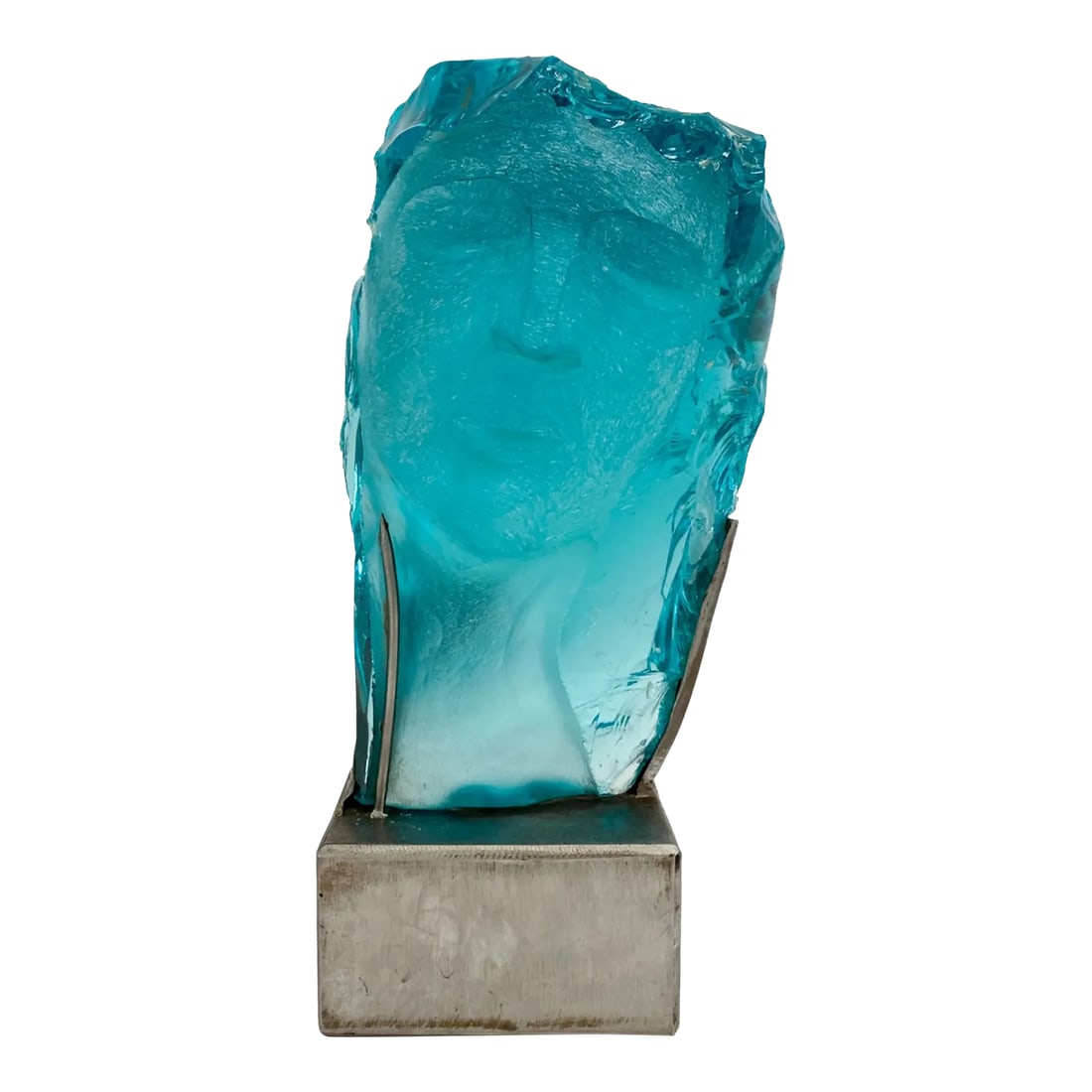 Suzanne Pascal 1914-2021 Carved Glass Sculpture: Large carved glass face. Signed on side of face. Dimensions: (Glass) H 15" x W 8" x D 9" (On stand) H 18.5" Pascal, Suzanne (1914-2021 ). American sculptor in glass, born in Montana, daughter of a