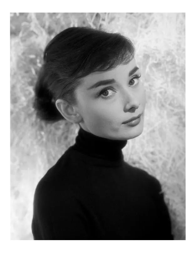 Audrey Hepburn Circa 1957: Audrey Hepburn, circa 1957. 11" x 14" silver gelatin fiber based print. Signed by photographer Bud Fraker. Printed later under the direct supervision of Sid Avery and signed on verso by Sid Avery.