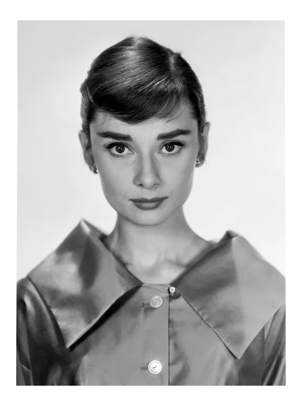 Audrey Hepburn Circa 1957: Audrey Hepburn, circa 1957. 11" x 14" silver gelatin fiber based print. Signed by photographer Bud Fraker. Printed under the direct supervision of Sid Avery and signed on verso by Sid Avery. #01 of an