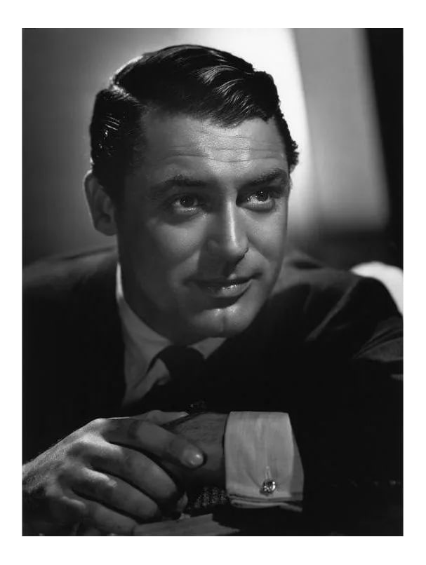 Cary Grant 1936: Cary Grant 1936. Photo by Ted Allan. 11" x 14" silver gelatin print. Printed later under the direct supervision of Sid Avery and signed on verso by Sid Avery. Edition #05 of an open edition. Condition