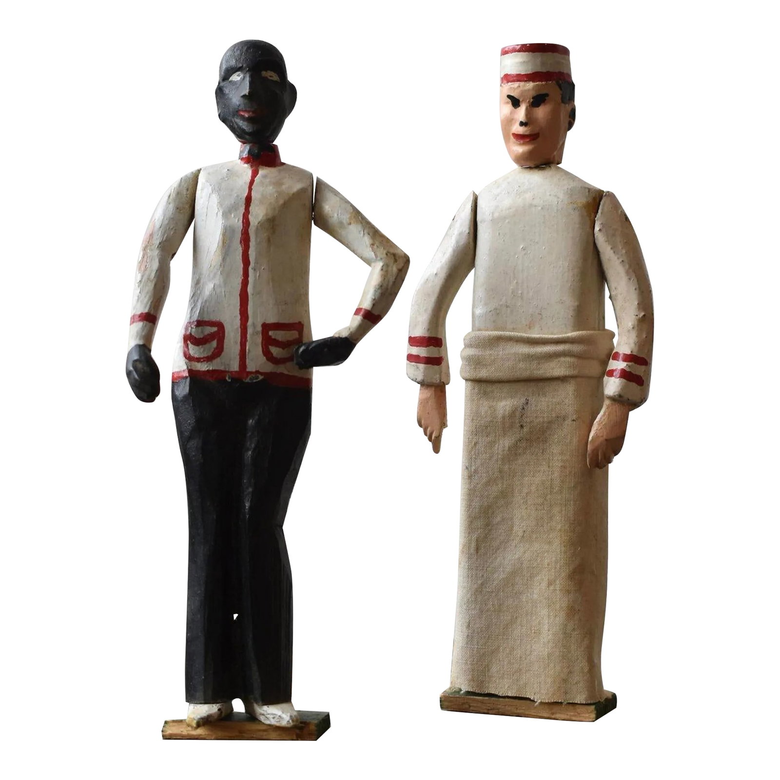 Antique Folk Art Carved Black + White Occupational Figures, a Pair, Circa 1940s: Antique Folk Art Carved Black + White Occupational Figures, A Pair, Circa 1940s. Rudimentary carved wood figures with hand-painted and cotton canvas occupational garb, rendered within a finite palette
