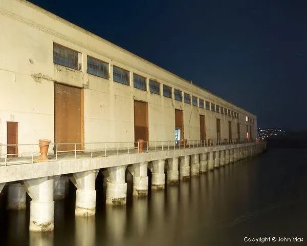 Contemporary Night Photograph "Cowell Theater" by John Vias: Note from the artist, John Vias: "I like the colors and repeating patterns in the buildings at Fort Mason in San Francisco." This 11" x 14" archival color photograph is presented in a 16" x 20"