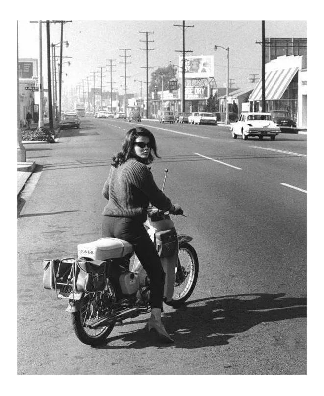 Ann-Margret on Her Honda Motorcycle 1964: Ann-Margret leaving Ken Whitmore's studio on her Honda motorcycle after an Album Cover Session in 1964. 11" x 14" silver gelatin print. Signed on verso by photographer Ken Whitmore. #01 of an open