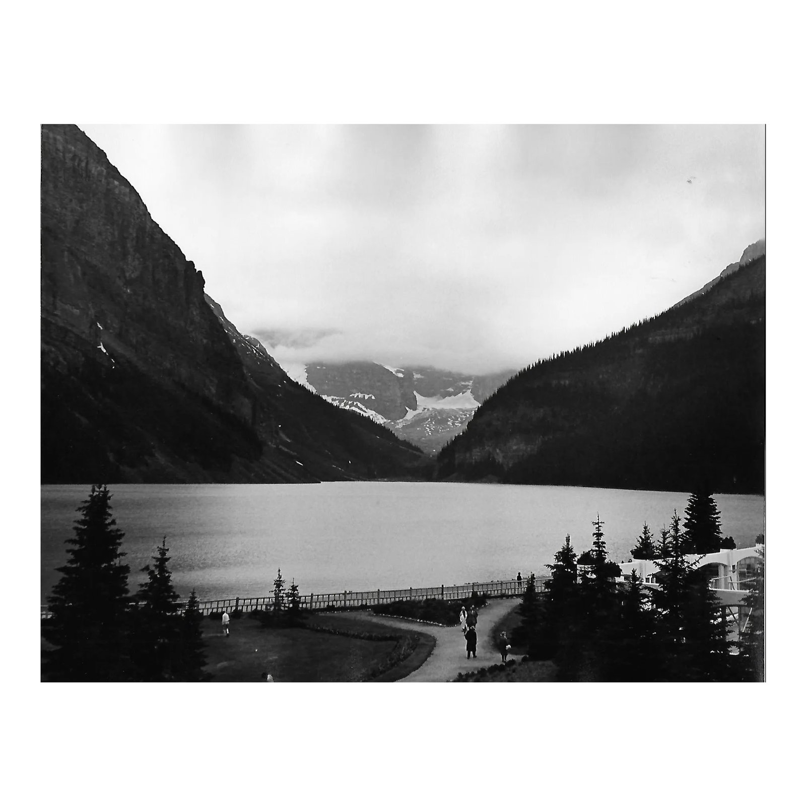 1969 Lake Louise Canadian Mountain Landscape: 1969 black and white photograph by Don Ware (1921-2006) of Lake Louise and snow covered mountains in Banff National Park in the Rocky Mountains, Alberta, Canada, west of Calgary. Titled and dated;