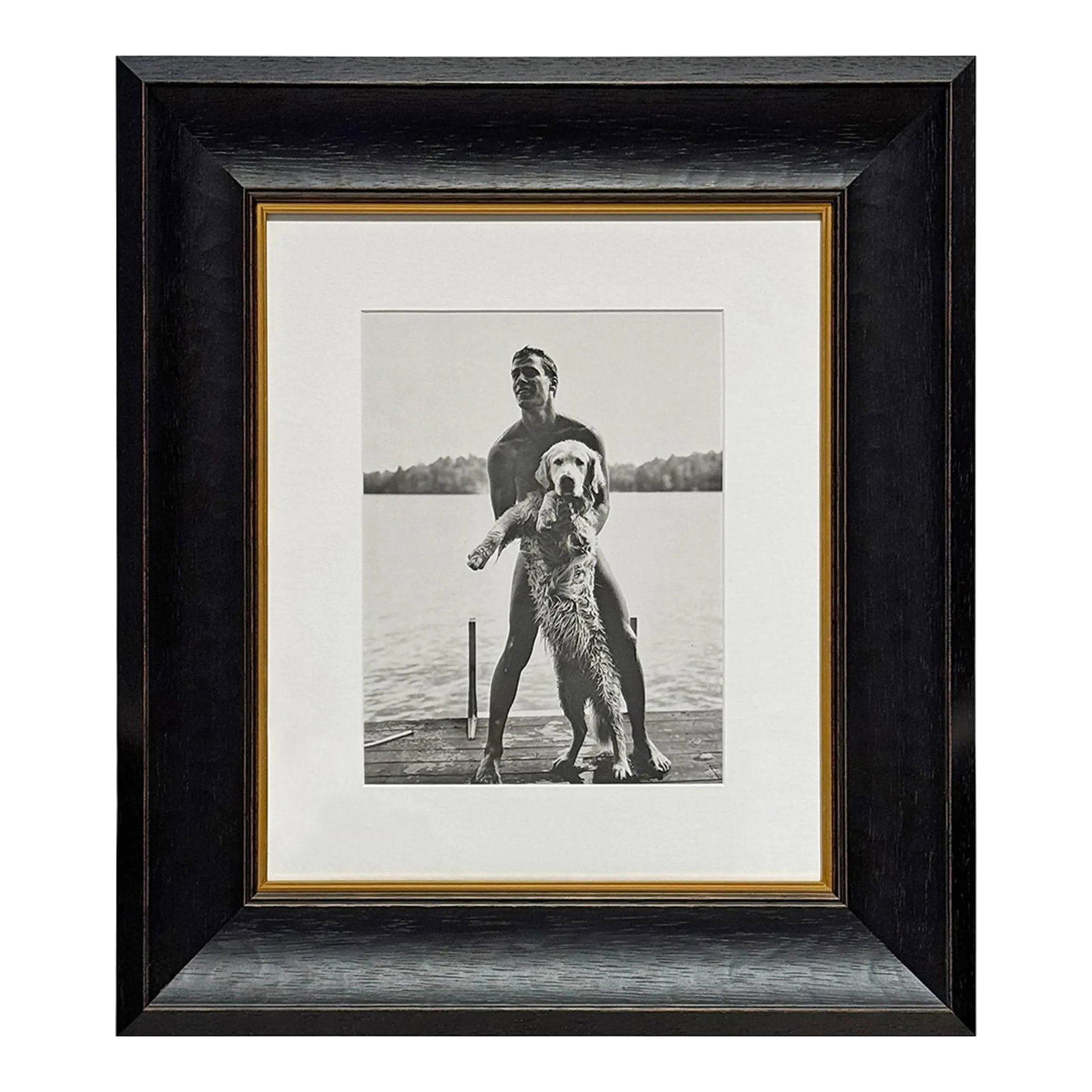 Ted and Rowdy, a Framed Photograph by Bruce Weber: In this 1987 photogravure, Bruce Weber captures Ted and a golden retriever, Rowdy, just after a swim in an Adirondack lake. Ted stands barefoot on a wooden dock, water still glistening on his skin, sm