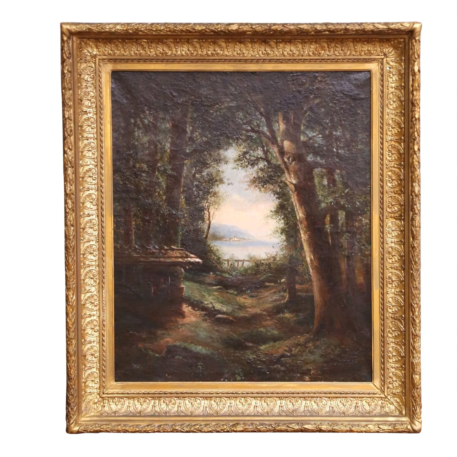 19th C. French Barbizon School Oil on Canvas Landscape in Giltwood Frame Signed: This atmospheric antique French oil on canvas painting, dating to circa 1870, presents a beautifully rendered forest clearing opening toward a shimmering lake and distant mountains, likely set in the