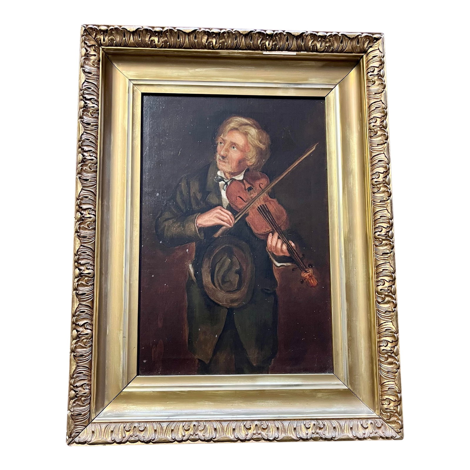 Antique Oil Painting, "The Old Violinist" After John George Brown: A warm and charming late 19th-early 20th century American School oil painting depicting an elderly violinist in the manner of celebrated genre painter John George Brown (1831-1913). Brown was widely