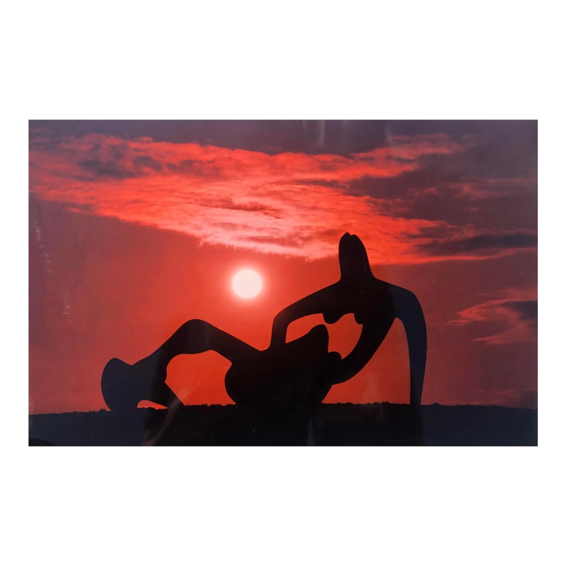 1993 Henry Moore at Sunset Color Photograph: Press photo in color by famous British photographer Phil Coburn of a large Henry Moore (1898-1986) sculpture at dusk. Press information attached to the back. Condition: Alterations: Original