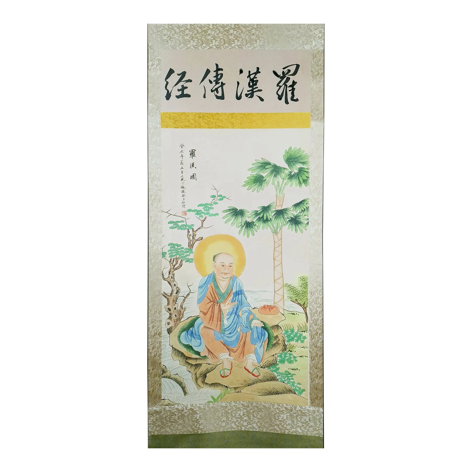 Chinese Sitting Luohan Scroll: Chinese sitting luohan scroll, colored inks on paper, mounted on a shimmering, gold and blue, silk brocade ten and ji in a floral vines pattern with a top ichimonji in a light and dark gold, silk