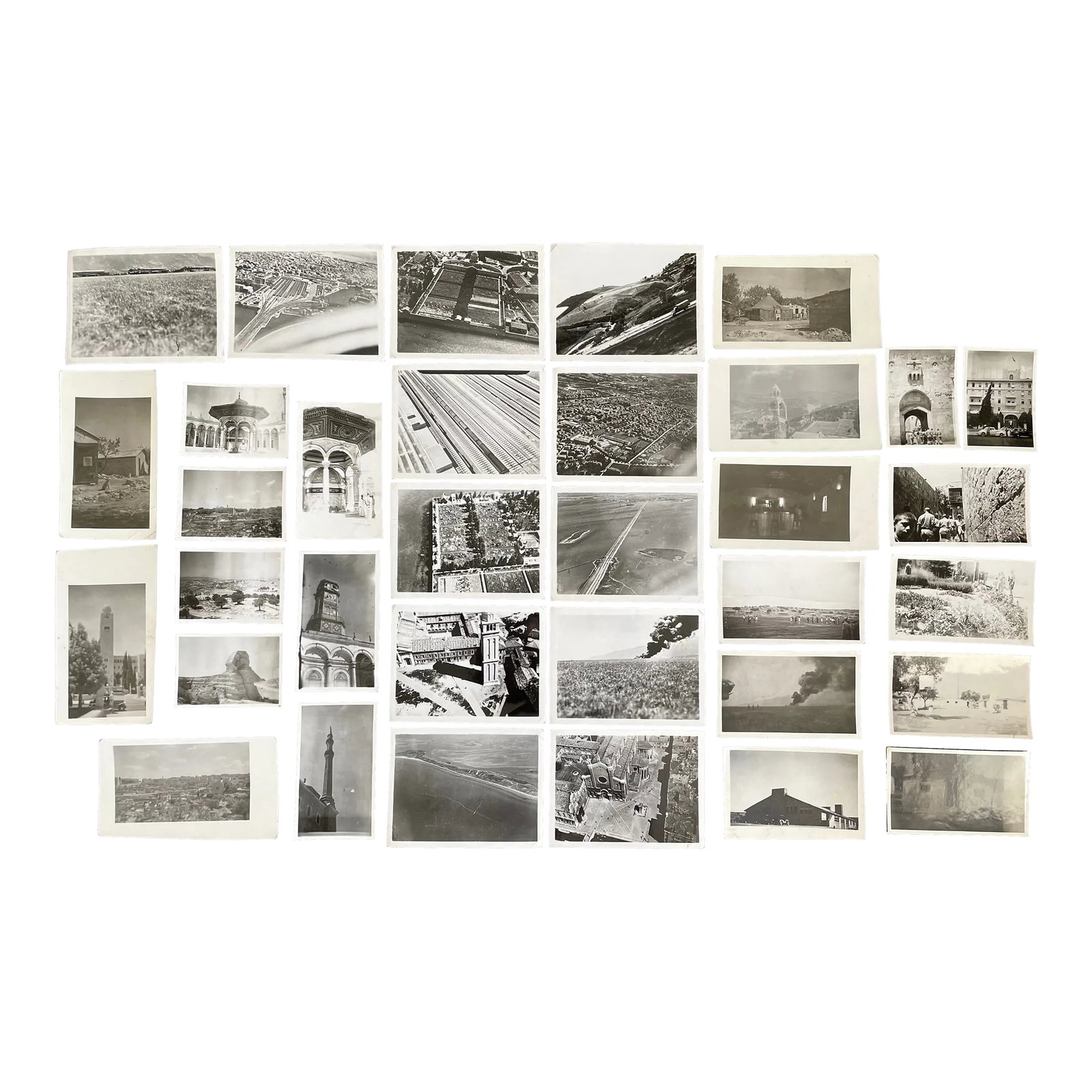 1930's Black and White Historical Photos - Lot of 34: This stunning collection captures a diverse array of scenes, ranging from aerial views of landscapes and cityscapes to powerful images of explosions and iconic landmarks. Featured among the landmarks