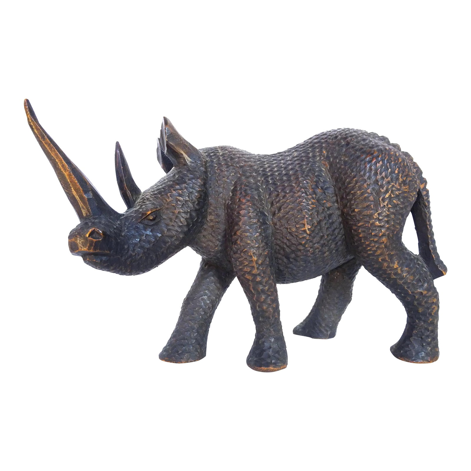Mid 20th Century African Carved Wood Black Rhinoceros Sculpture: This hand-carved wooden table-top sculpture of a black rhinoceros is chip-carved in a realistic manner with understanding of the animal's spirit and activity, and with expert attention to detail. It i