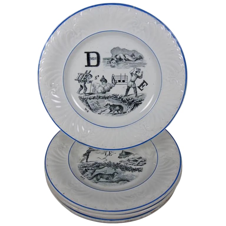 Creil Et Montereau French Rebus Puzzle Dessert Plates- Set of 6: A set of six French Rebus Puzzle dessert plates, circa 1841 to 1876, marked Creil et Montereau. Transfer printed in black on a white earthenware body. When solved, the picture puzzle spells out a