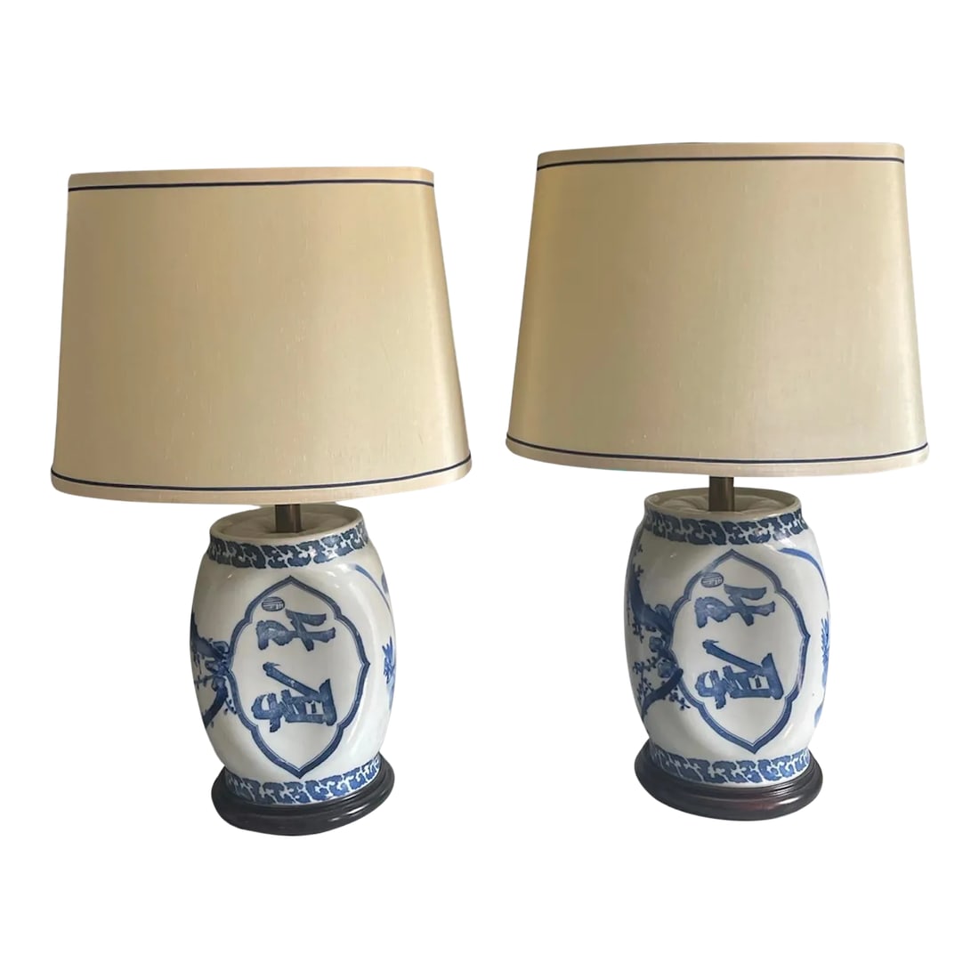 Antique Blue and White Lamp Set With Original Shades - A Pair: A pair of Chinese porcelain blue and white opium pillow lamps with calligraphy and foliate decoration resting on carved wooden bases. Circa 1900. Original silk shades with blue piping included. Shade