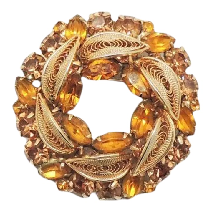 Vintage 1950s Signed Napier Filigree Faux-Citrine Brooch: This is part of Chairish's Costume Jewelry assortment. 1950s goldtone filigree prong set marquise and small round faux-citrine with round faux-topaz wreath style brooch with security clasp. Marked