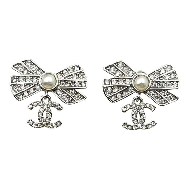 Chanel Silver Ribbon Row CC Crystal Piercing Earrings - 2 Pieces: Chanel Silver Ribbon Row CC Crystal Piercing Earrings *Marked 22 *Made in France *Comes with the original box, pouch and booklet -It is approximately 0.75'' x 0.75''. -In a pristine condition
