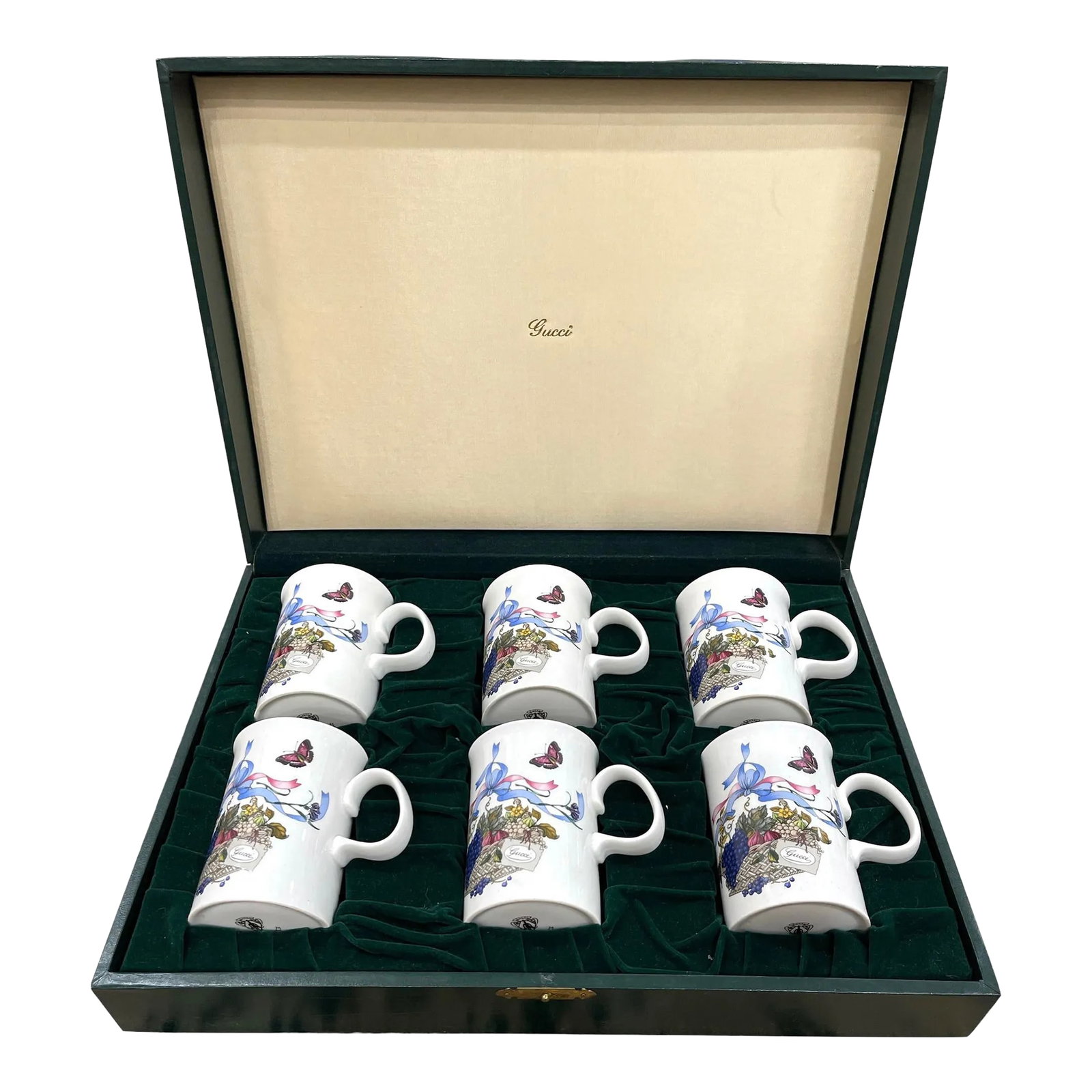 Gucci Set/6 Vintage Bone China Mugs W" Original Box: Vintage set of 6 Bone China GUCCI mugs. Made in England. Hand painted flowers and fruits in a basket with ribbons. Gold lined rim. Includes original green leather presentation suitcase with velvet