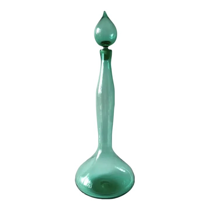 1950s Wayne Husted for Blenko Sea Foam Green Genie Bottle Decanter: Sea foam green 5815L Genie bottle decanter designed in 1958 by Wayne Husted for Blenko. Decanter measures 25" by 8.5" and is signed with the acid etched Blenko signature on the bottom. In very good vi