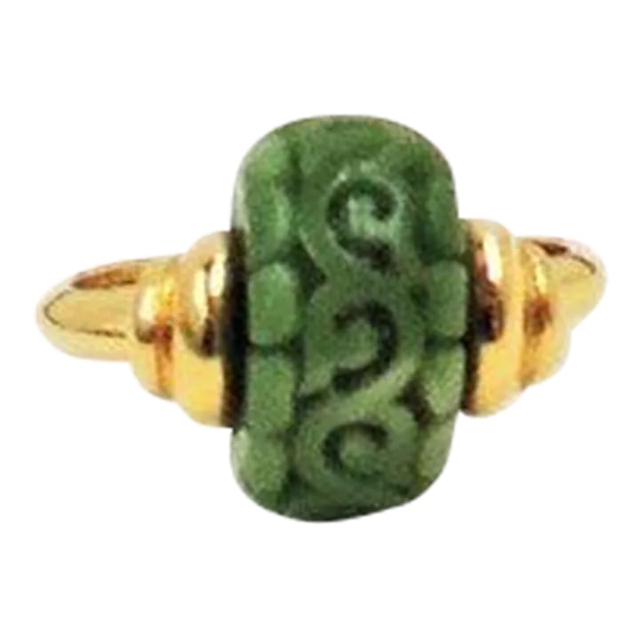 Vintage Signed Trifari Carved Faux-Jade Ring Size 6.5: This is part of Chairish's Costume Jewelry assortment. Goldtone carved resin faux-jade ring with inside sizer. Marked "Trifari." Size 6 1/2 at the largest, but can be worn if your finger is smaller.