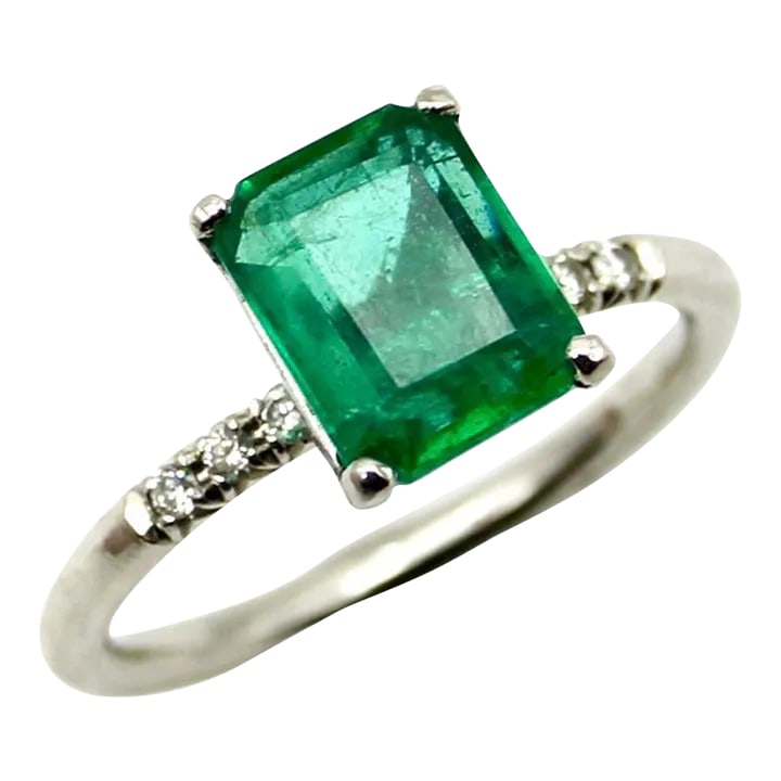 Platinum Emerald and Diamond Solitaire Ring Size 5.75: This is part of Chairish's Fine Jewelry assortment. A beautiful rectangular emerald cut emerald is prong set into a platinum band, embellished with six single cut diamonds that add sparkle to the
