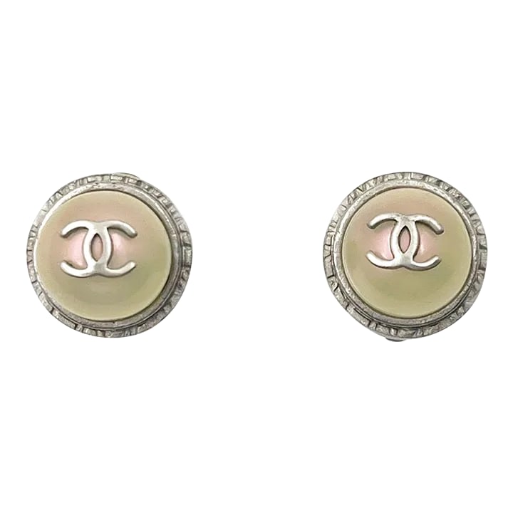 Chanel Silver CC Iridescent Pearl Gumball Clip on Earrings - 2 Pieces: This is part of Chairish's Costume Jewelry assortment. Chanel Silver CC Iridescent Pearl Gumball Clip on Earrings *Marked 98 *Made in France *Comes with the original box -It is approximately 0.55" x 0