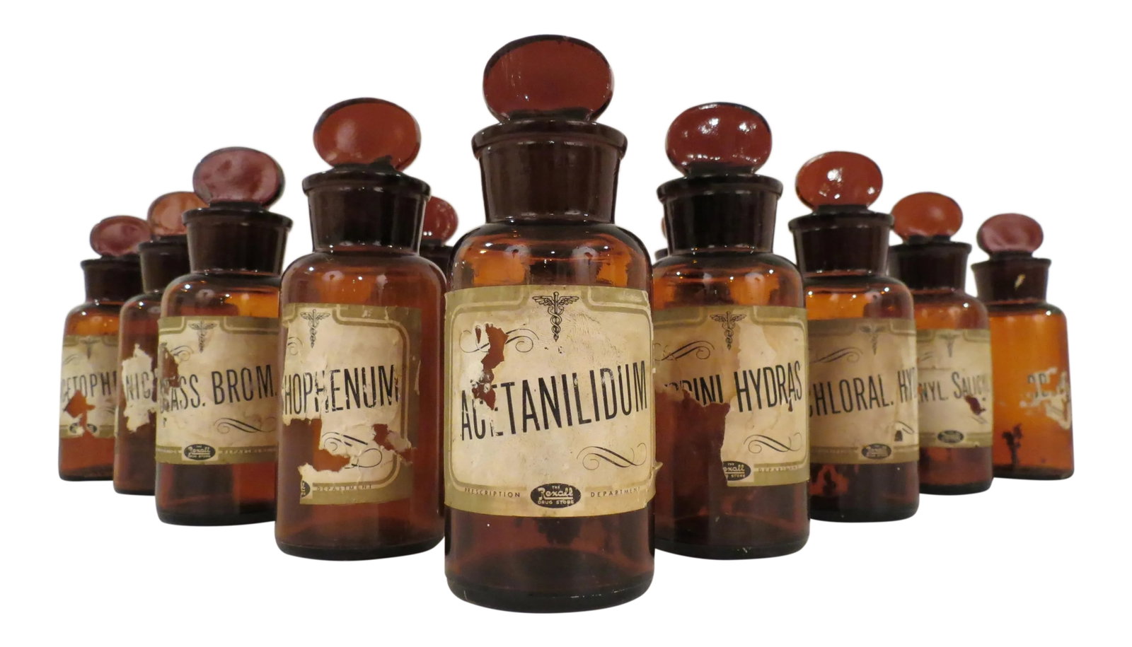 Antique Labeled Glass Lidded Amber Apothecary Bottles - Set of 12: Never going to find a set like this again. Rare set of 12 antique amber glass apothecary or pharmacy bottles all with original lids and labels. Each measures, 2.45" Dia x 6" H. Condition: Alterations: