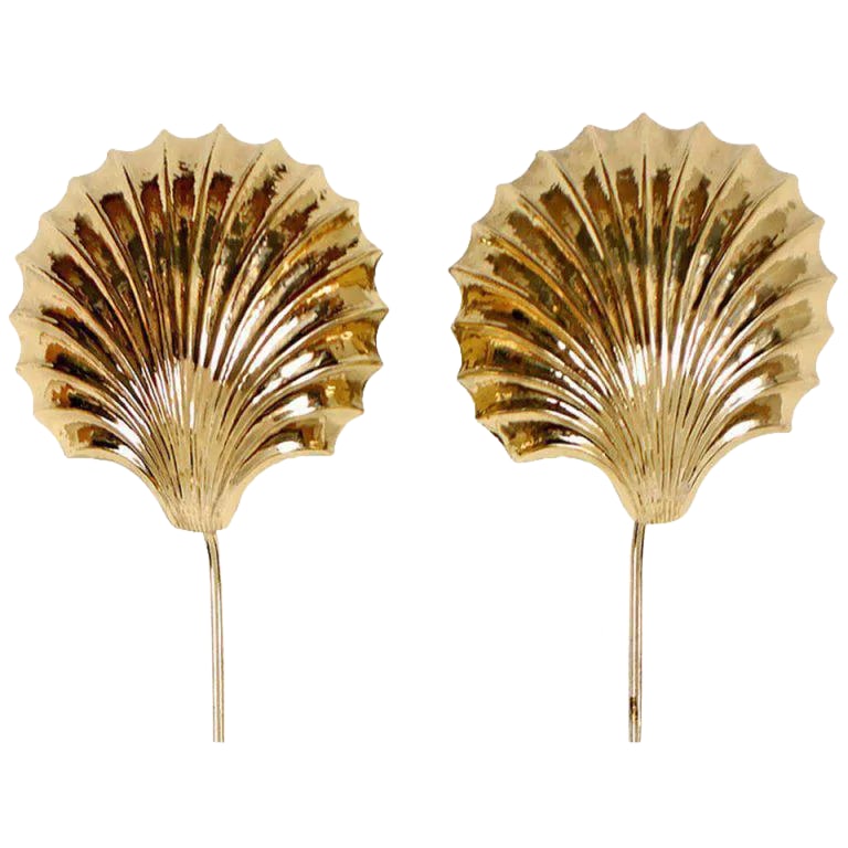 Cast and Hammered Brass Shell Sconces With Cord Covers Cicra 1970s: Stunning pair of brass shell sconces that mount in place. They glow atmospherically against a wall. Tubular brass cord covers provide a finished look. Condition: Alterations: Original Condition Unalte