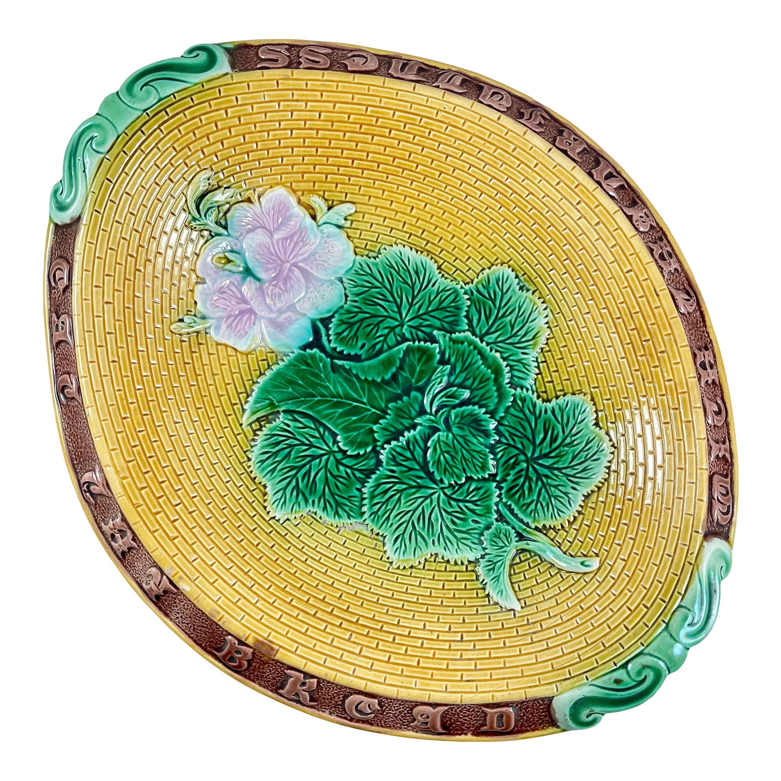 Adams & Bromley English Majolica Geranium Motto Bread Tray: An English majolica glazed bread tray made by Adams & Bromley, circa 1875. An oval tray with a rolled rim brown border showing a motto molded in raised lettering, 'Eat Thy Bread With Thankfulness.'