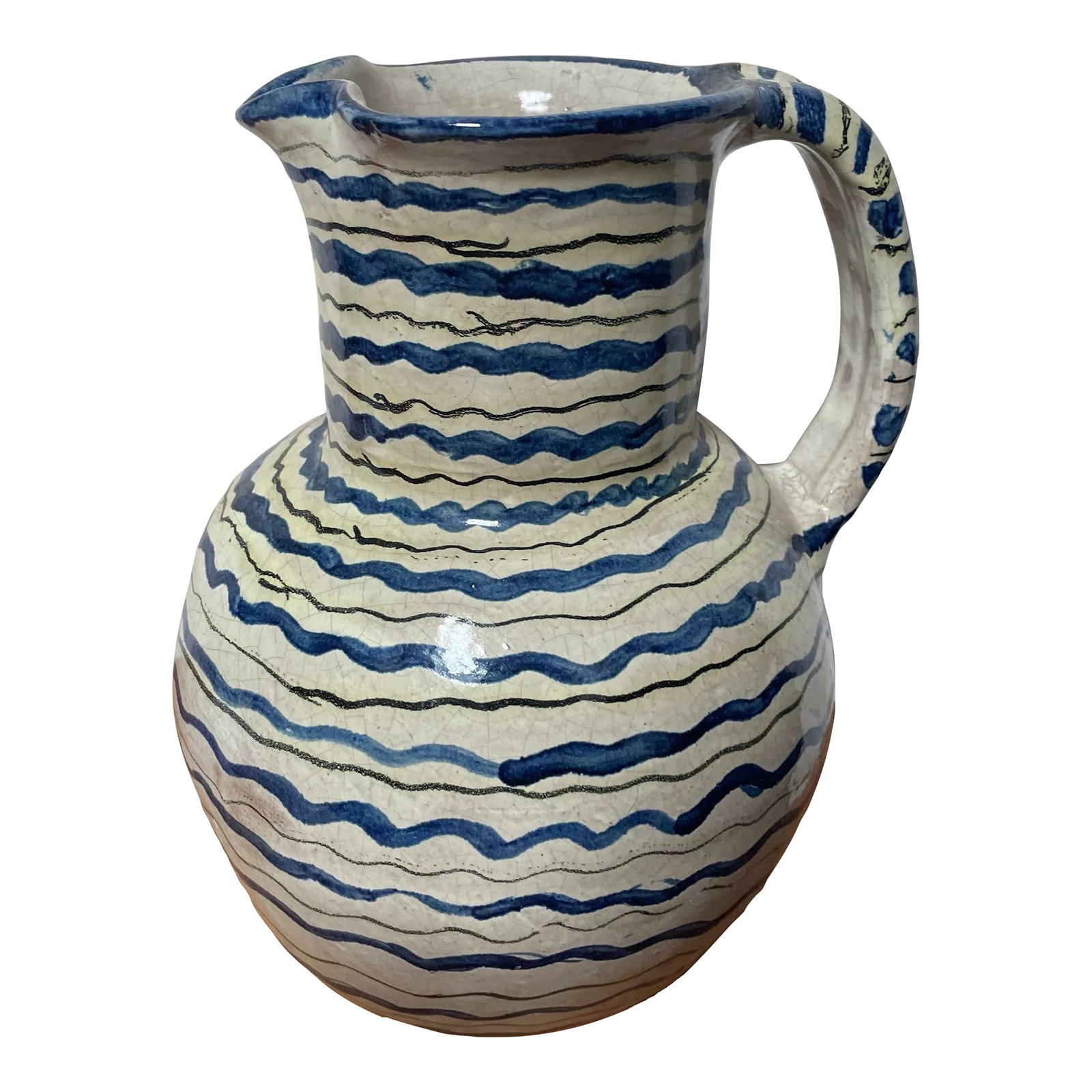 Antique Mediterranean Hand-Painted Terracotta Pitcher: A terracotta pitcher or jug with handle. Of unknown origin, likely Spanish or Italian circa early 20th century. Glazed and hand painted with squiggly green, blue and black lines of varying thickness