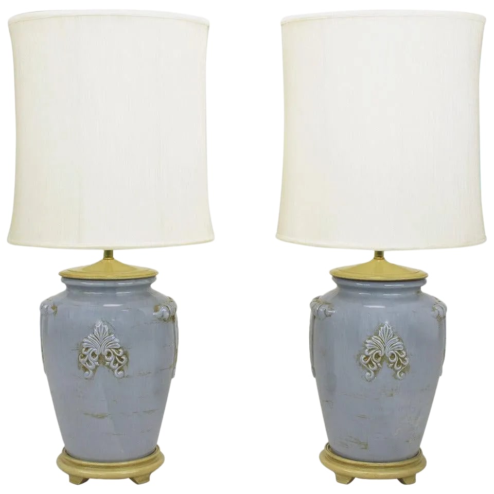 Periwinkle Blue Vintage Glazed Urn-Form Table Lamps - a Pair: Pair of periwinkle blue ceramic vase or urn form table lamps with Vintage glaze. Cap and base are carved and lacquered wood with a bone glaze, brass stem and double socket cluster. Sold sans shades.