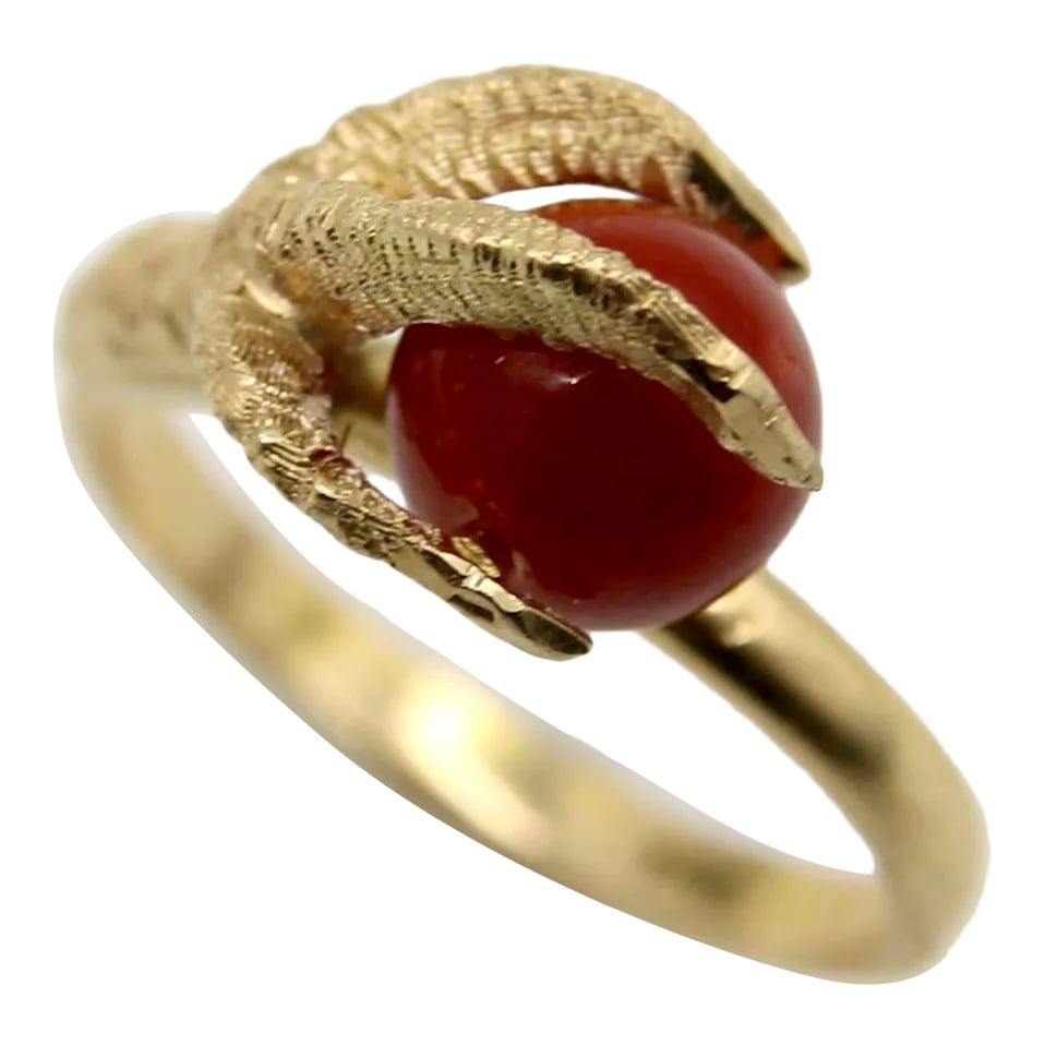 Vintage 18k Gold Sardinian Red Coral Bead and Claw Ring Size 7: This is part of Chairish's Fine Jewelry assortment. In this 18k gold vintage ring, a three-dimensional claw rises up and clasps a coral bead. The claw is impressively lifelike, with a matte texture