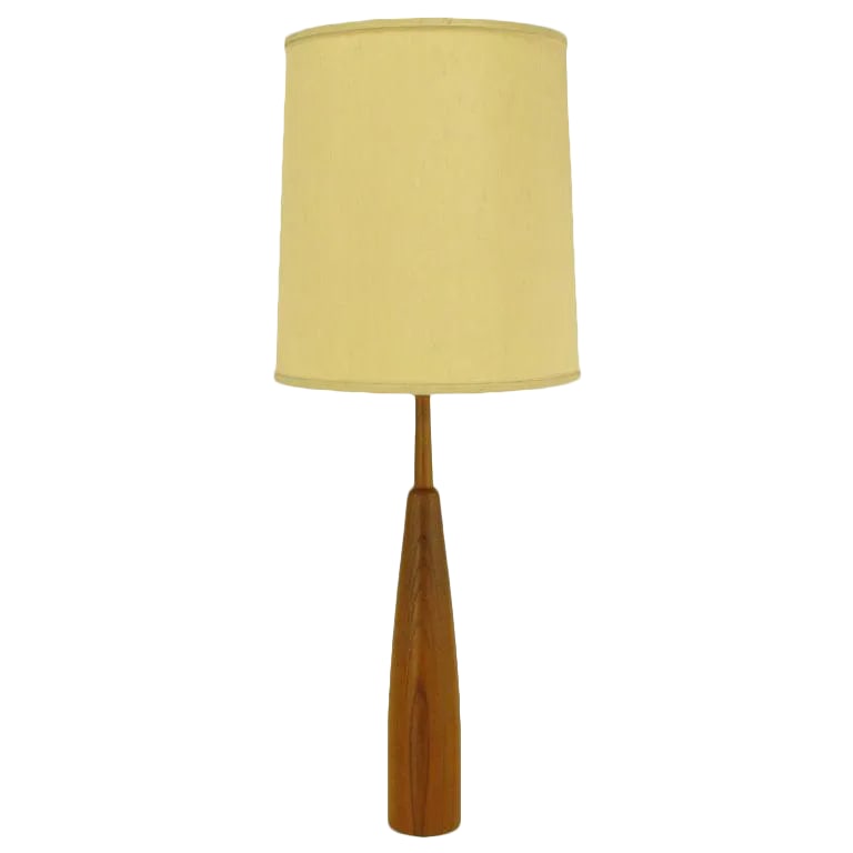 Teak Bottle Form Table Lamp: Very finely constructed teak wood table lamp. Solid teak wood body is bottle shaped with a teak wood stem. Brass harp and socket. Sold sans shade. Condition: Alterations: Original Condition Unaltered
