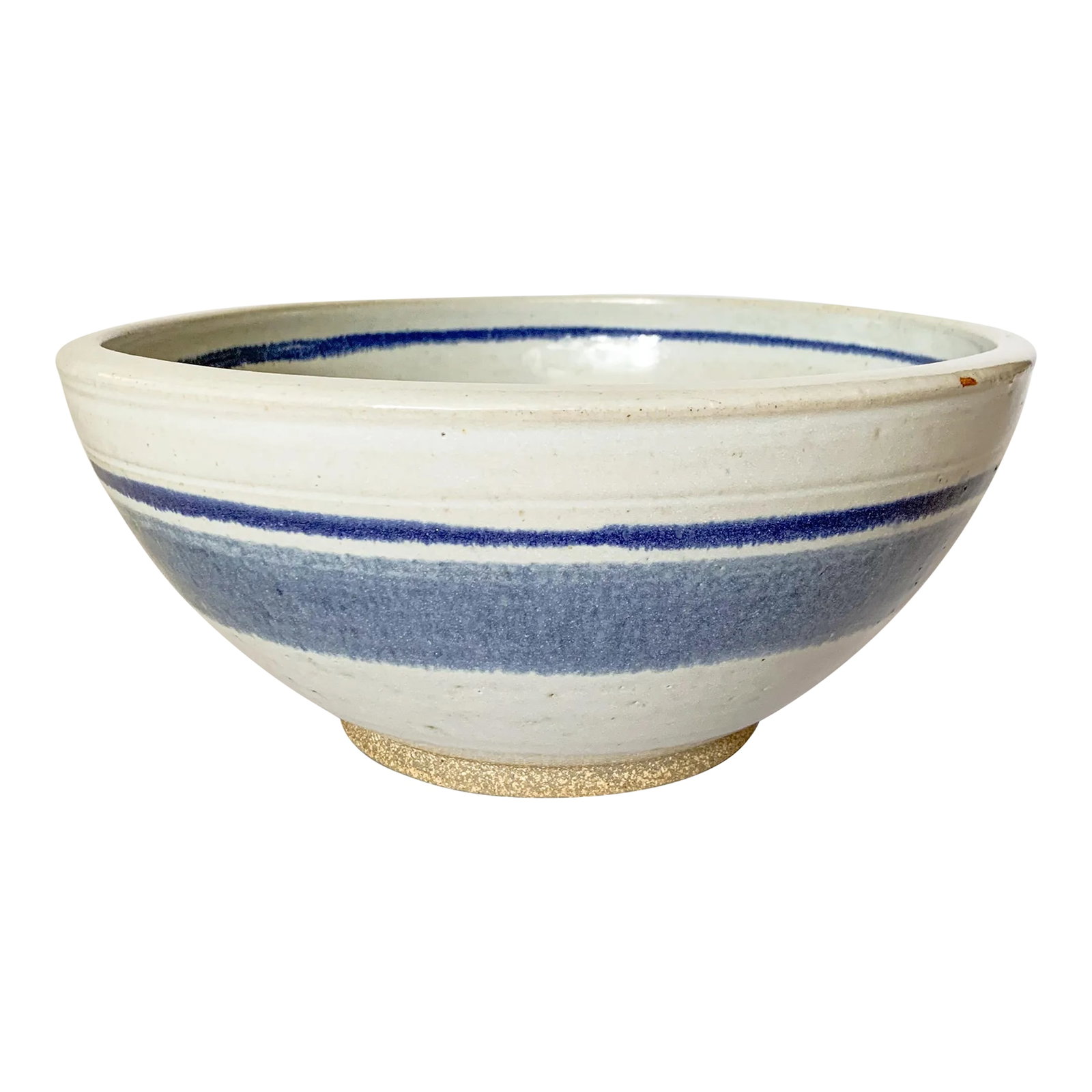 Vintage Large Studio Pottery Blue Striped Bowl: We love a good blue and white piece of pottery, and this large mixing bowl is no exception. The milky glaze shows off darker blue glazed rings inside and out. It is an excellent example of high
