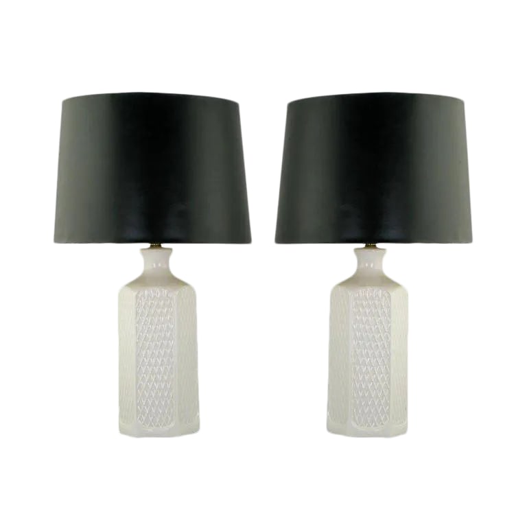 Hexagonal White Ceramic Table Lamps With Geometric Relief - a Pair: Pair of hexagonal white ceramic vessel table lamps with a raised relief of open triangles (or Vs) on every side. Sold sans shades. Condition: Alterations: Original Condition Unaltered Imperfections: