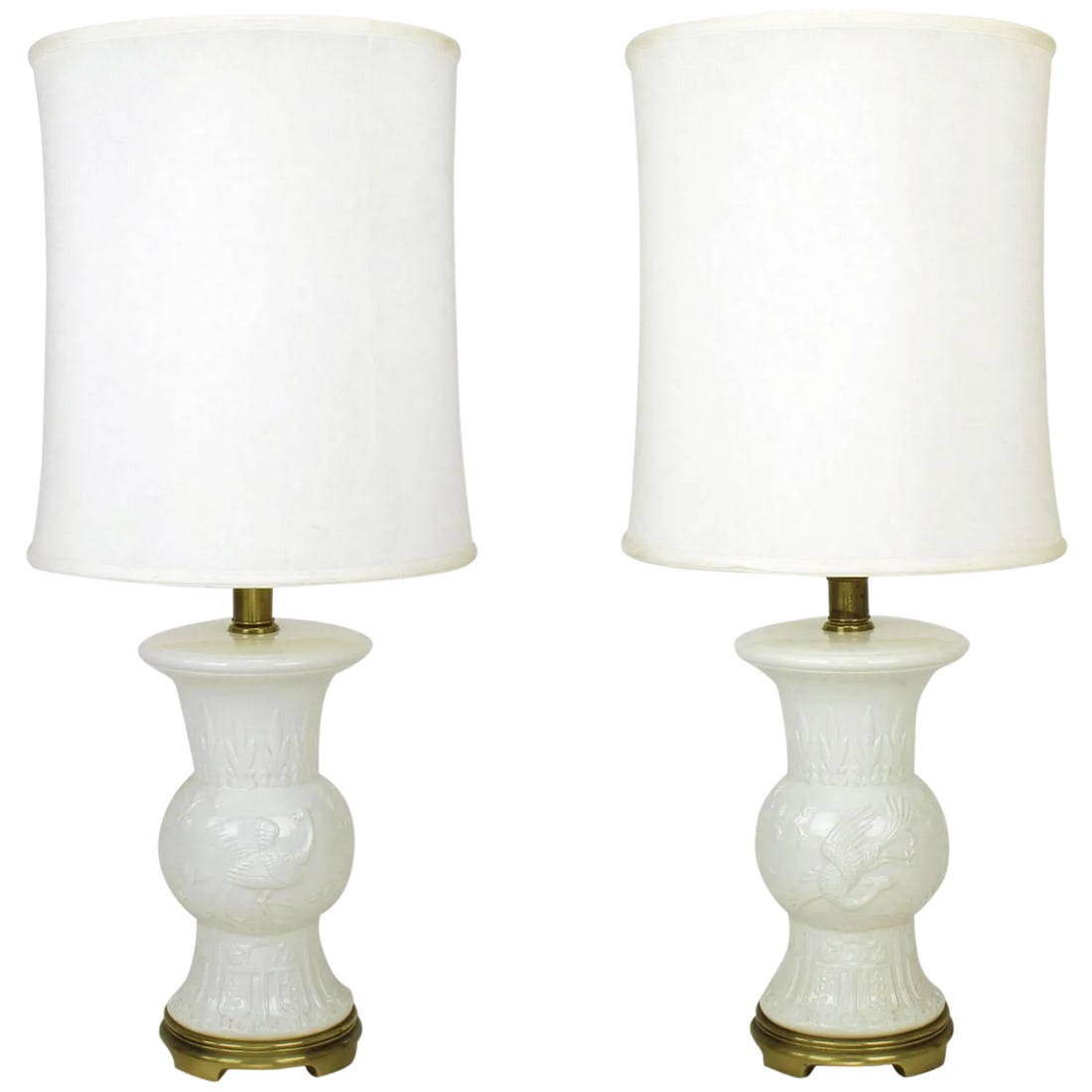 Frederick Cooper White Porcelain Table Lamps - a Pair: Pair of vintage Frederick Cooper white porcelain table lamps with raised relief design depicting flora and fauna. Vintage bronze base. Sold sans shades. Condition: Alterations: Unknown Imperfections: 