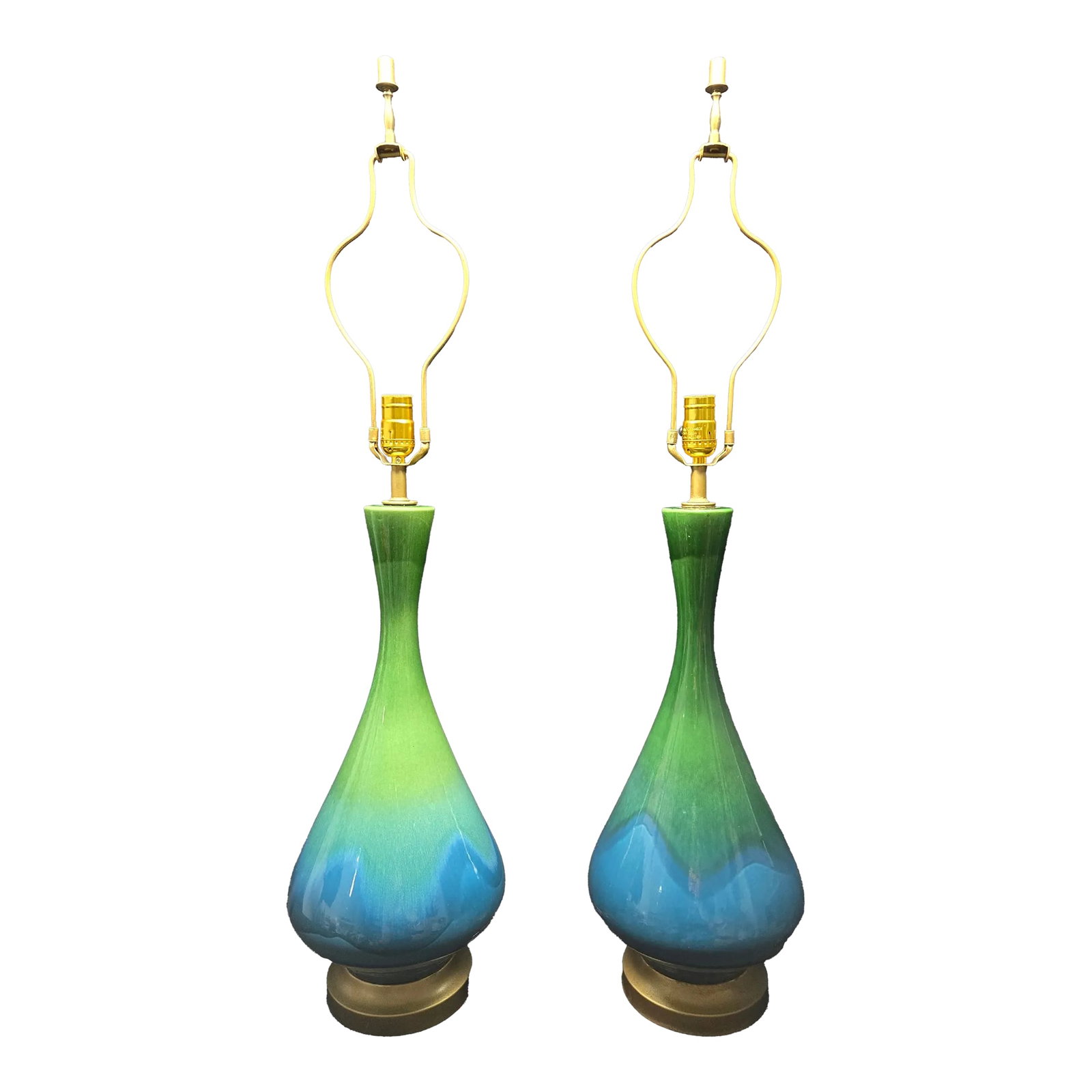 Mid-Century Modern Green and Blue Ceramic Lamp Pair: These stylish lamps are perfect for a mid-century styled home, constructed with a bottle-shaped ceramic body glazed in cheerful shades of green dripping over blue towards the bottom. Finished with a g