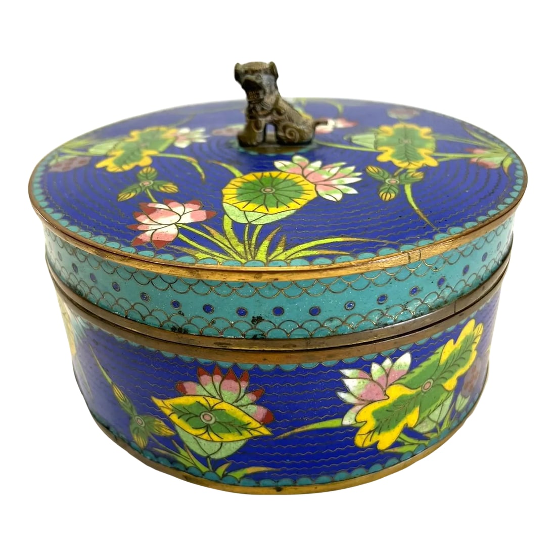 Early 20th Century Antique Chinese Cloisonne Round Covered Box With a Bronze Foo Dog FInial: The metal art form of painting glass powder on designated areas on metal dated back to the Yuan Dynasty 13th to 14th century. It was believed the Mongols brought the objects back from conquered