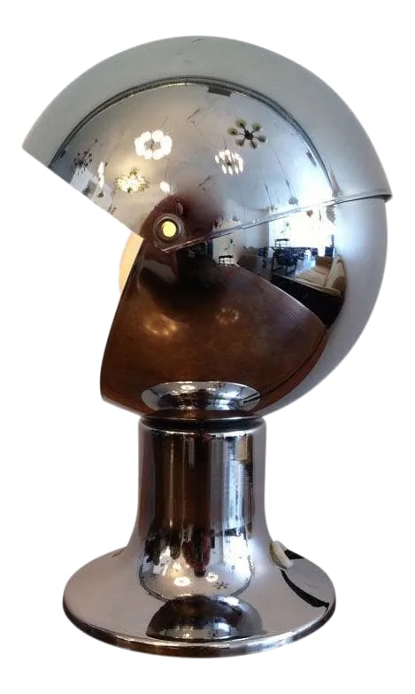 1960s Chrome Eclipse Lamp: A chrome Italian desk/table light with an adjustable shade. Condition: Alterations: Restored Imperfections: Some Imperfections Condition Notes: Excellent Origin: Italy Materials & Techniques: