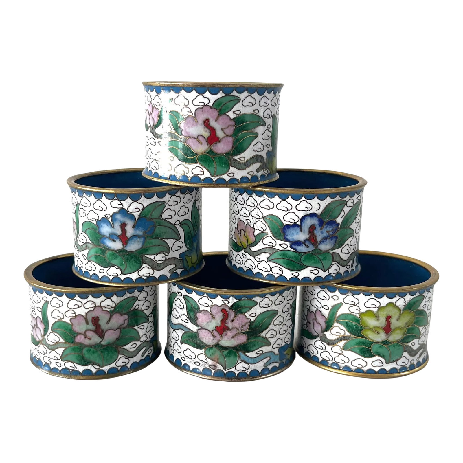 Vintage Cloisonne Napkin Rings, Set 6: Set of 6 early 20th century cloisonne napkin rings. Set on a white base with lovely gold swirls and colorful blossoms and foliage. Inner ring is blue enamel. Condition: Alterations: Original