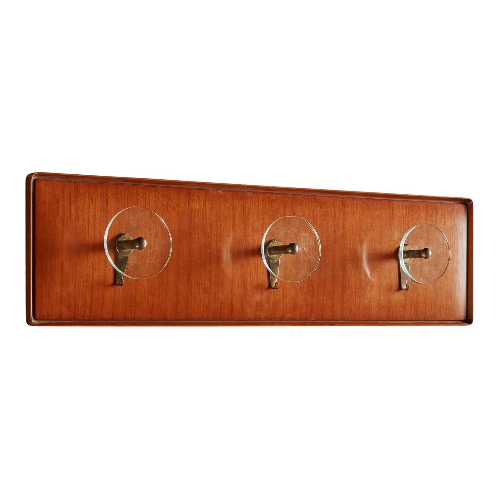 Wood + Glass Wall Mounted Coat Rack, Italy 1960s: A 1960s Italian rectangular wall mounted coat rack composed of wood in a warm, cherry hue. This coat rack features three exaggerated round glass knobs and patinated brass hardware. Sourced in Italy,