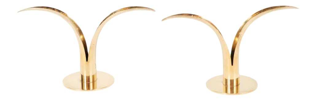 Mid-Century Modern Polished Brass Lily Candleholders by Konst of Sweden - a Pair: This elegant and graphic pair of candleholders were realized by the esteemed Swedish maker, Konst, circa 1960. The feature curved tapered forms- suggesting two lily petals, rising upwards from a