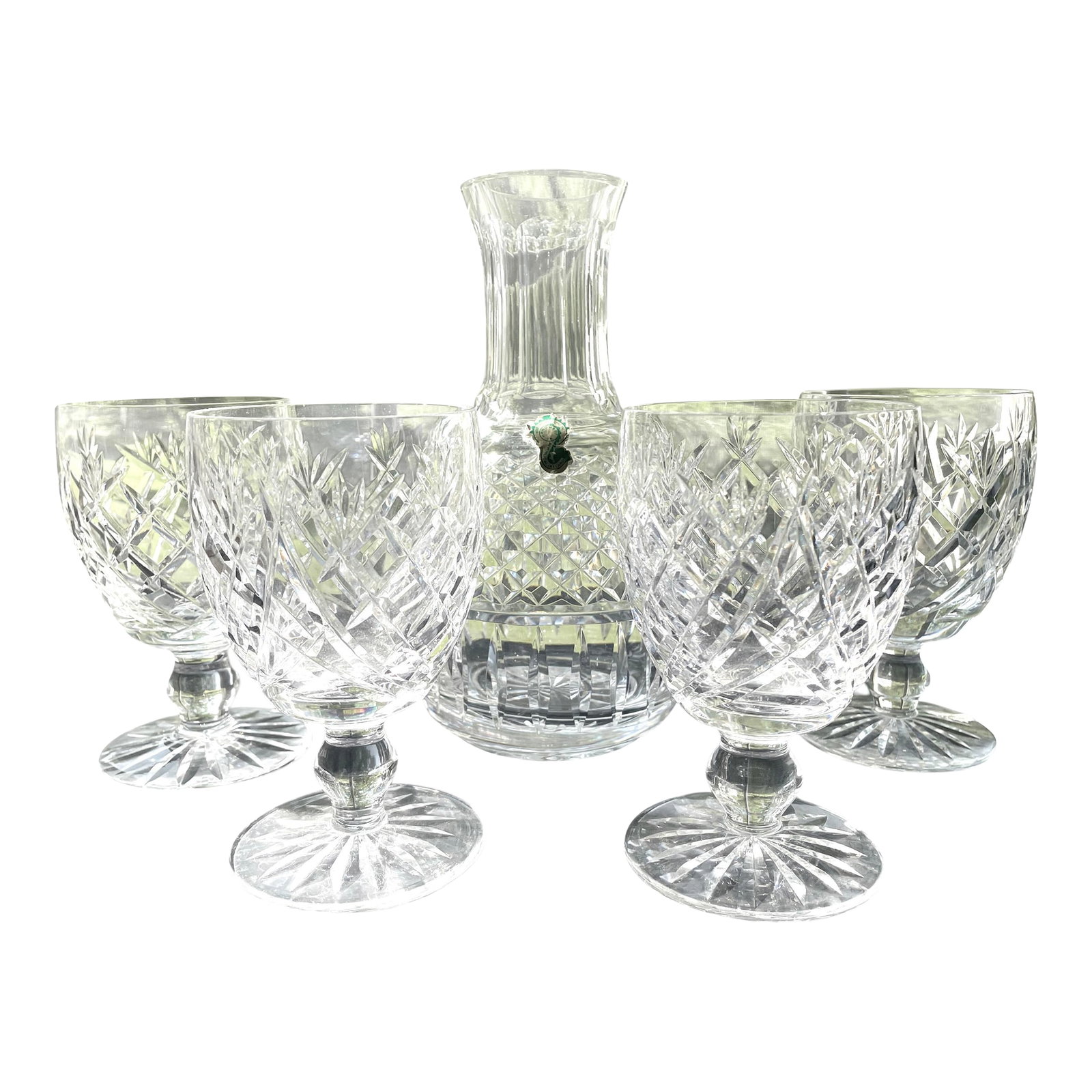 1960s Waterford Crystal 5-Piece Carafe and Goblet Set: Vintage but unused 5 piece set of Waterford Crystal carafe and four goblets in the Donegal pattern. Every piece is in perfect condition. This set dates to the years when Waterford Crystal was made